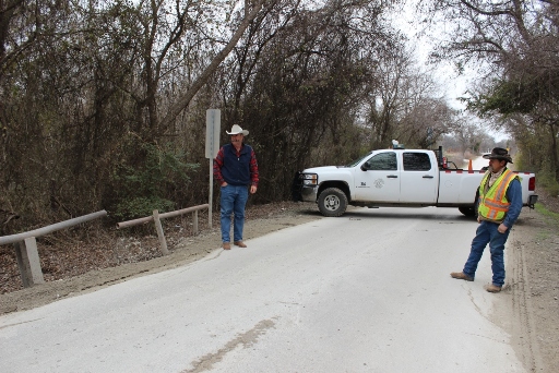 Precinct 3 Commissioner Larry Walden and Foreman Hunter Crutsinger look over a bridge on Old Brock Road that will be replaced and widened